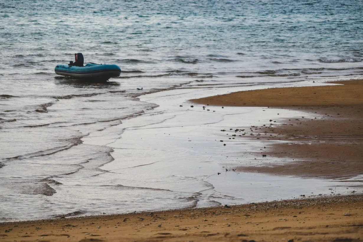 blue inflatable raft on the beach